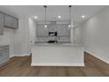 Bright, modern kitchen with a large island, gray cabinetry, and stainless steel appliances at 642 Cottage Landing Dr, Summerville, SC 29485