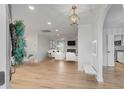 Bright open-concept living room with hardwood floors and modern furnishings at 704 N Godfrey Park Pl, Charleston, SC 29407