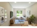 Bright living room featuring a large window with lots of natural light and a comfortable sectional couch at 7614 Indigo Palms Way, Johns Island, SC 29455