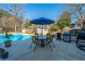 Backyard patio area with a pool, table, chairs, grill, and outdoor furniture at 8512 Kennestone Ln, Charleston, SC 29420