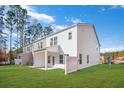 Townhome backyard featuring green grass, trees, and a privacy fence at 8741 Silver Perch Ln, North Charleston, SC 29420