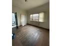 Bright living room featuring hardwood floors, a window with blinds, and plenty of natural light at 90 Romney St, Charleston, SC 29403