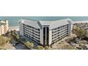 An eye-level exterior view of a condominium showcasing its architecture, balconies, and proximity to the beach at 9002 Palmetto Drive #514 1/13 Share, Isle of Palms, SC 29451