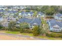 Aerial view of a neighborhood featuring colorful townhouses, mature trees, and well-maintained landscaping at 1225 Blakeway St # 406, Charleston, SC 29492