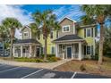 A picturesque view of well-maintained townhouses, showcasing the landscaped grounds, mature trees, and ample parking at 1225 Blakeway St # 406, Charleston, SC 29492