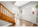 Bright foyer with wood-look floors, staircase, and a white front door with sidelights welcomes you home at 1401 Cooper River Blvd, Moncks Corner, SC 29461