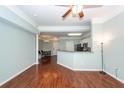 Open concept living room with wood floors flowing into kitchen and dining area at 1433 Telfair Way, Charleston, SC 29412