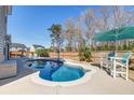 Beautiful backyard pool with seating, an umbrella, and a basketball hoop for outdoor fun at 146 Stagecoach Ave, Summerville, SC 29486