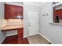Inviting home entryway with a built-in desk, coat hooks, and neutral ceramic tile at 1755 Central Park Rd # 5107, Charleston, SC 29412