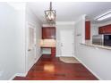 Inviting entryway with built-in desk, modern light fixture, and seamless flow into the kitchen at 1755 Central Park Rd # 5107, Charleston, SC 29412