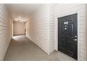 Hallway of building leading to unit with black door numbered 5107 and wood paneled walls at 1755 Central Park Rd # 5107, Charleston, SC 29412