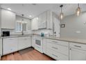 Bright kitchen with white cabinetry, stainless steel appliances, and hardwood floors at 2017 Long Bend Dr, Seabrook Island, SC 29455