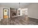 Spacious living room featuring a stone fireplace, ceiling fan, and hardwood floors at 204 Tram Blvd, Summerville, SC 29486