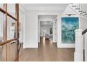 Inviting foyer showcasing hardwood floors, staircase and stylish decor at 213 Amberjack Ln, Charleston, SC 29492