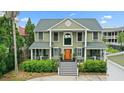 Inviting two-story home featuring a charming front porch, manicured landscaping, and a welcoming entrance at 2156 Cheswick Ln, Mount Pleasant, SC 29466