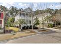Charming two-story home with double porches, manicured landscaping, and a classic Lowcountry design at 2516 Willbrook Ln, Mount Pleasant, SC 29466