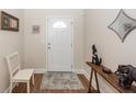 Bright entryway with white door, wooden console table, and laminate wood flooring at 322 Freeland Way, Moncks Corner, SC 29461