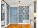 Entryway with light blue walls, textured wallpaper and a wooden parquet floor at 330 Concord St # 14 A, Charleston, SC 29401