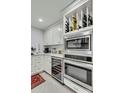 Kitchen features a built-in wine rack, stainless steel appliances and white cabinetry at 330 Concord St # 14 A, Charleston, SC 29401
