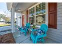Inviting front porch features Adirondack chairs and a side table for relaxation with outdoor living at 3621 Locklear Ln, Mount Pleasant, SC 29466
