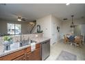 Open concept kitchen with stainless steel appliances, breakfast bar, that flows into dining area at 3621 Locklear Ln, Mount Pleasant, SC 29466