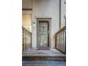 Inviting front door with glass panel, wooden steps, and decorative pineapple accent at 401 Yacht Harbor Ct, Isle of Palms, SC 29451