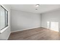 Sunny bedroom features hardwood floors and a large window at 4928 Gaynor Ave, North Charleston, SC 29405