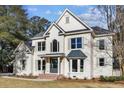 Attractive white two-story home featuring a gray roof, well-kept lawn, and classic window designs at 499 Lackland Ct, Mount Pleasant, SC 29464