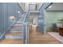 Elegant foyer with light blue wall, staircase, and hardwood floors, creating a bright and open entrance at 499 Lackland Ct, Mount Pleasant, SC 29464