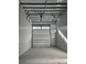 Interior view of a storage unit featuring a concrete floor and closed overhead door at 567 Faison Rd # 8, Mount Pleasant, SC 29466