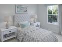 Bright bedroom with plush carpeting, large windows, and a queen-size bed with decorative pillows at 605 Red Monarch Way, Moncks Corner, SC 29461