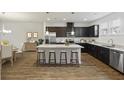 Well-lit kitchen with dark cabinets, stainless steel appliances, and center island at 612 Mclernon Trce, Johns Island, SC 29455