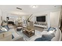 Open concept living room with stairs, kitchen view, and hardwood floors at 612 Mclernon Trce, Johns Island, SC 29455