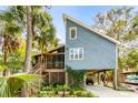 Unique coastal home with eye-catching architecture, a screened porch and ample covered parking at 619 E Erie Ave, Folly Beach, SC 29439