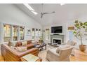 Bright living room featuring a cozy fireplace, skylights, hardwood floors, and comfortable seating at 619 E Erie Ave, Folly Beach, SC 29439