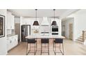 Modern kitchen featuring stainless steel appliances, white cabinetry, and an eat-in island at 641 Cottage Landing Dr, Summerville, SC 29485