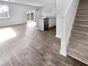 Open floor plan featuring a staircase, hardwood floors, and a modern kitchen in the background at 669 Silver Spruce St, Summerville, SC 29486