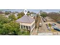 An aerial shot highlighting path to parking for a two-story home with manicured trees and a cobblestone street at 90 E Bay St, Charleston, SC 29401