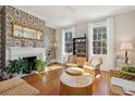 Bright living room features hardwood floors, decorative fireplace, and large windows with natural light at 100 Queen St, Charleston, SC 29401