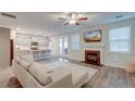 Open living room with fireplace, kitchen access, and backyard view from doors at 109 Forest Springs Rd, Moncks Corner, SC 29461