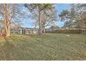Expansive backyard featuring a lush lawn, mature trees, and a wooden fence, perfect for outdoor activities and privacy at 111 Summit Ave, Goose Creek, SC 29445