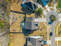 Aerial view of a suburban home with a fenced backyard, playground, and long driveway at 136 Stagecoach Ln, Summerville, SC 29483