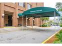 Ashley House condo building entrance with a green awning and driveway at 14 Lockwood Dr # 7J, Charleston, SC 29401