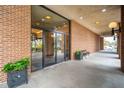 Condo building entrance featuring planters, brick walls, and glass doors at 14 Lockwood Dr # 7J, Charleston, SC 29401