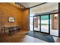 Condo lobby featuring tile flooring, a bench, and glass doors at 14 Lockwood Dr # 7J, Charleston, SC 29401