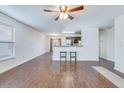 Bright living room featuring beautiful flooring, a ceiling fan, and easy access to the kitchen at 152 Coosawatchie St, Summerville, SC 29485