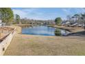 Picturesque pond view surrounded by lush greenery and neighboring homes in a quiet community at 152 Coosawatchie St, Summerville, SC 29485