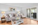 Inviting living room featuring a plush sofa, stylish decor, and access to an outdoor balcony at 2012 Long Bend Drive, Seabrook Island, SC 29455