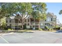 Well-maintained condo featuring a private balcony, mature trees, and convenient parking at 2135 Landfall Way, Seabrook Island, SC 29455