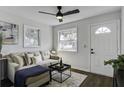 Cozy living room with a sofa and coffee table, featuring a ceiling fan and natural light at 2218 Dover St, North Charleston, SC 29405